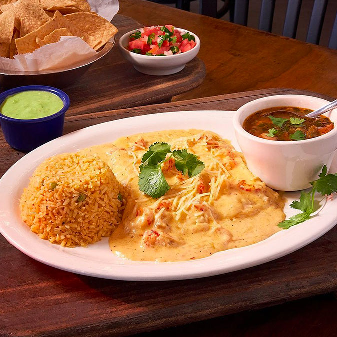 Texas-style Mexican plate with rice, cheesy chicken, beans, and guac at Maria Mia Tex-Mex Cantina.