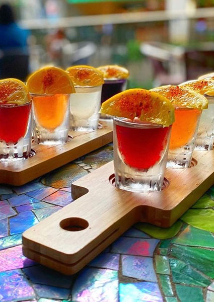 Colorful shots with orange slices at Maria Mia Tex-Mex Cantina Restaurant Bar, College Station.