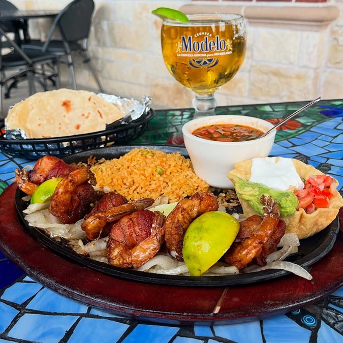Grilled shrimp with rice, beans, and beer at Maria Mia Tex-Mex Cantina in College Station.