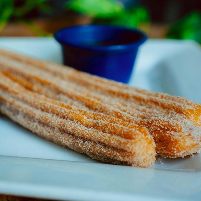 Two churros with chocolate sauce at Maria Mia Tex-Mex Cantina Restaurant Bar, College Station.