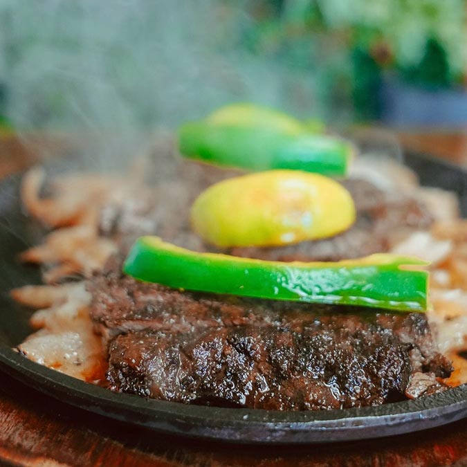 Grilled steak, green peppers, and avocado served hot at Maria Mia Tex-Mex Cantina in College Station.
