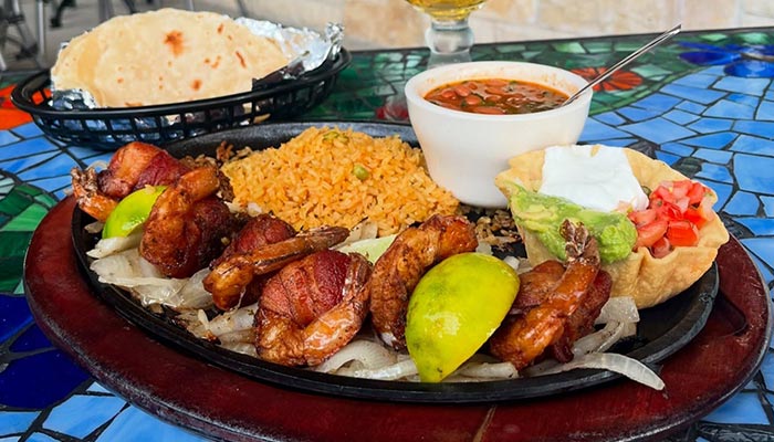A plate of bacon-wrapped shrimp and sides at Maria Mia Tex-Mex Cantina in College Station, Texas.