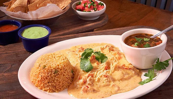A plate of rice, creamy chicken, beans & salsa from Maria Mia Tex-Mex Cantina in College Station.