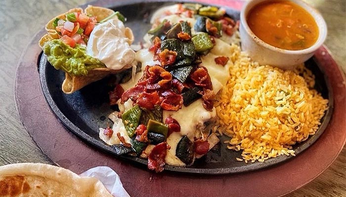 A plate at Maria Mia Tex-Mex Cantina in College Station, TX featuring grilled chicken and more.