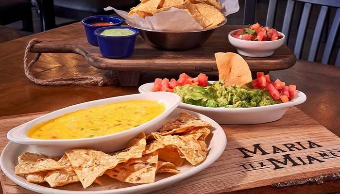 A table at Maria Mia Tex-Mex Cantina Restaurant Bar in College Station, Texas with chips and dips.